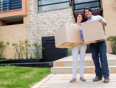 Large family home move in progress with packed furniture and cartons